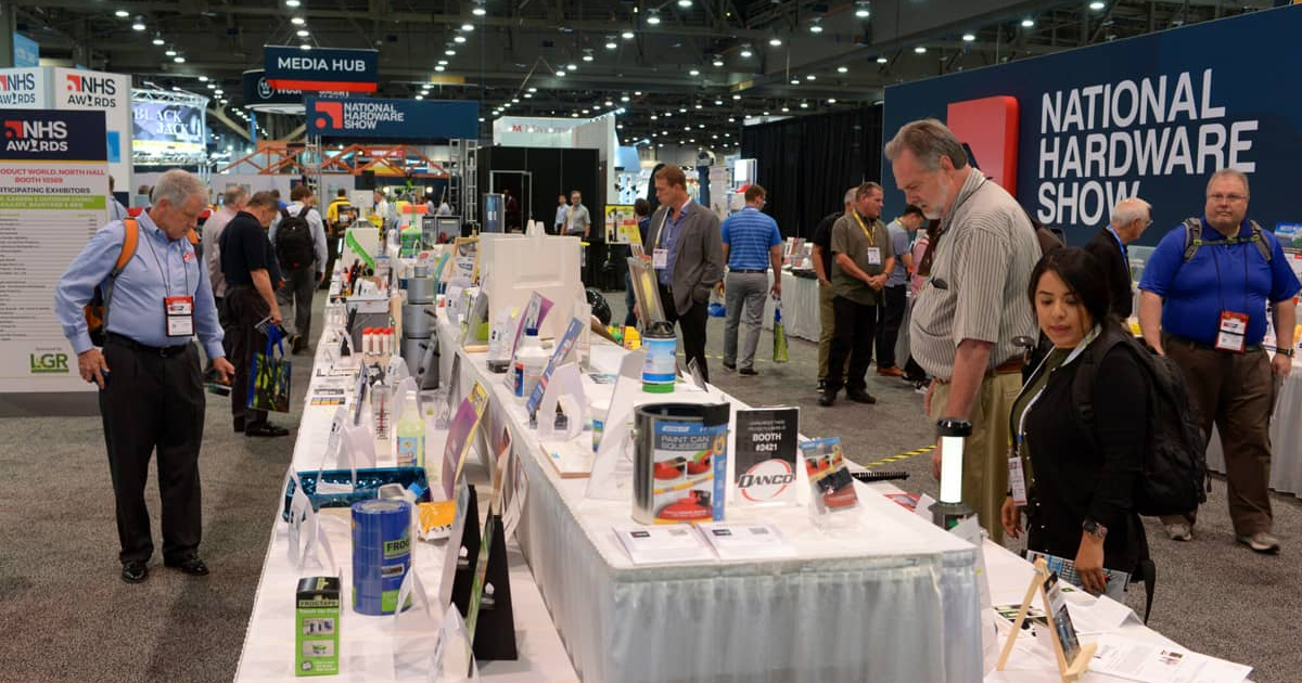 Buyers examine product displays on long tables at the National Hardware Show in Las Vegas.